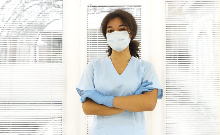 Travel Nurses Can Avoid Scams - nurse in nose mask