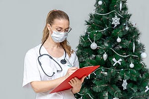 Female travel nurse writing some records while on Christmas assignments