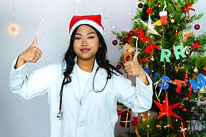 Female travel nurse giving thumbs up while on Christmas assignments