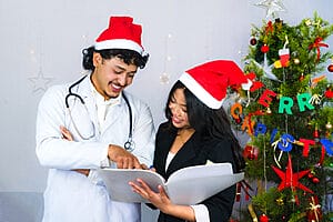 Female and male travel nurse smiling on Christmas assignments