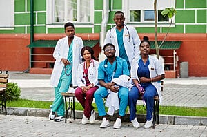 Travel nurses sitting in front of their house in a suitable neighborhood